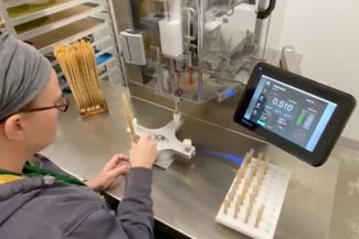 JuanaOne being used to roll pre roll joints